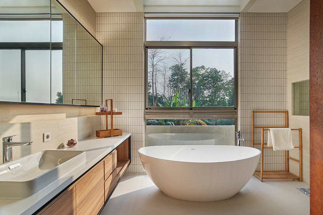 Contemporary bathroom with freestanding tub and large window