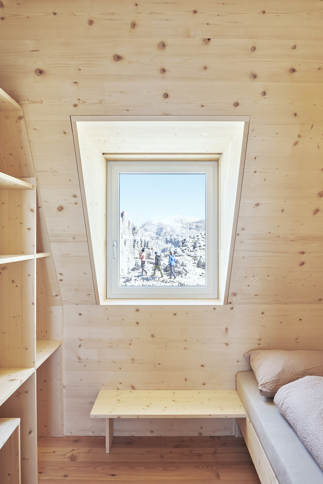 Cozy wooden interior with a window view of snowy landscape.