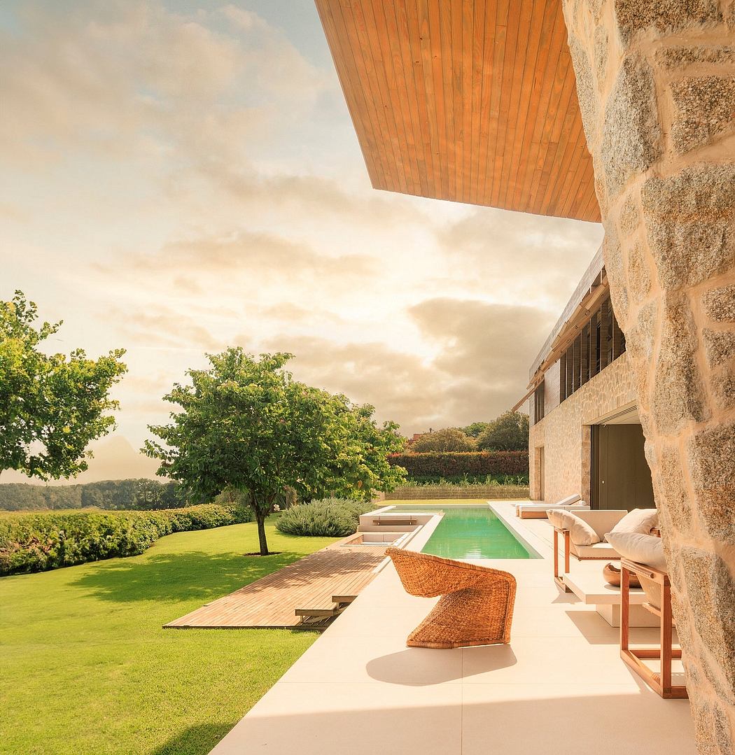Modern house patio with pool overlooking a scenic view at sunset.