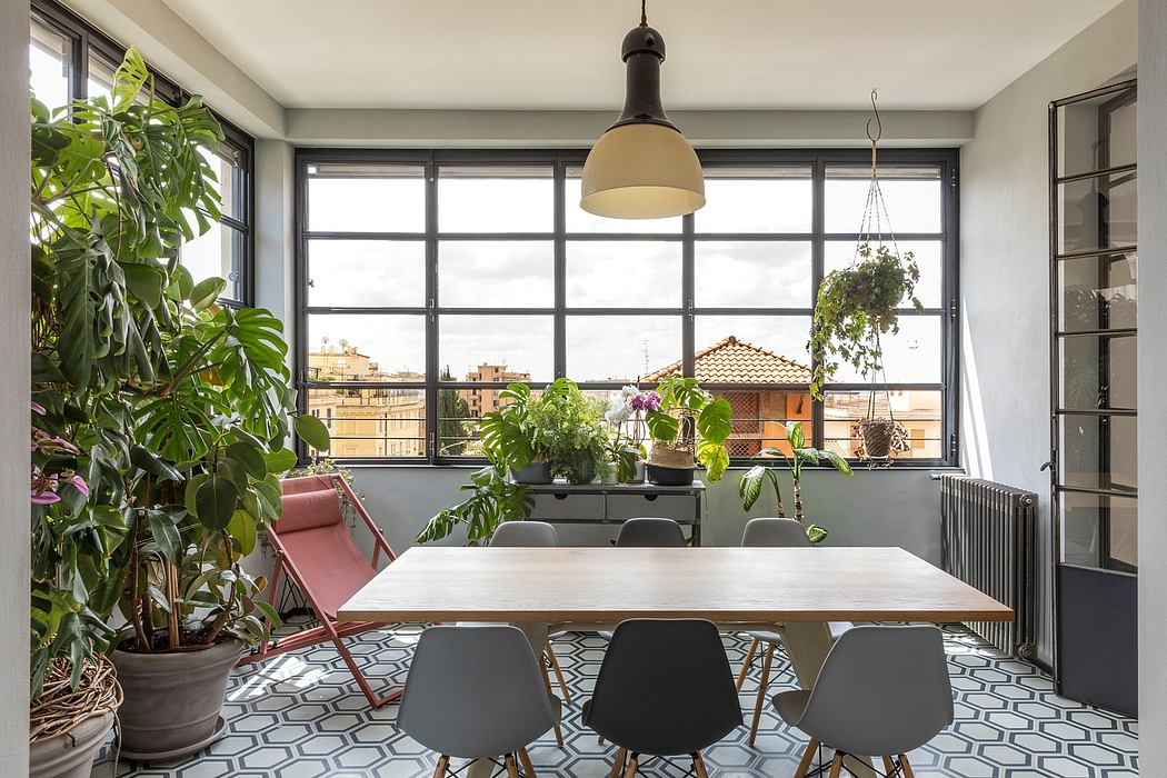 Contemporary dining space with patterned floor, large windows, and indoor plants.