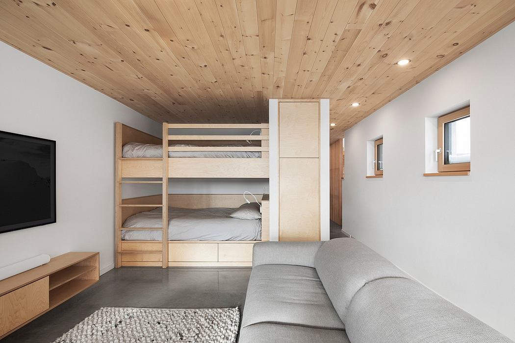Minimalist interior with wooden bunk beds and sleek design.