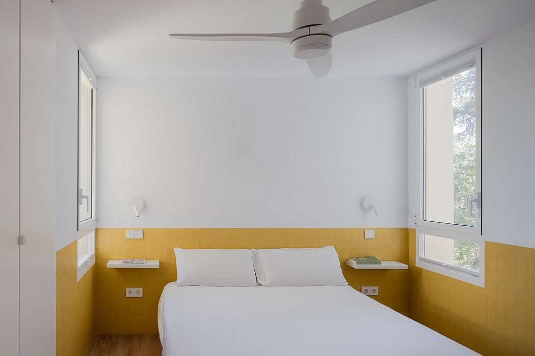 Minimalist bedroom with white walls, yellow wainscoting, and large windows