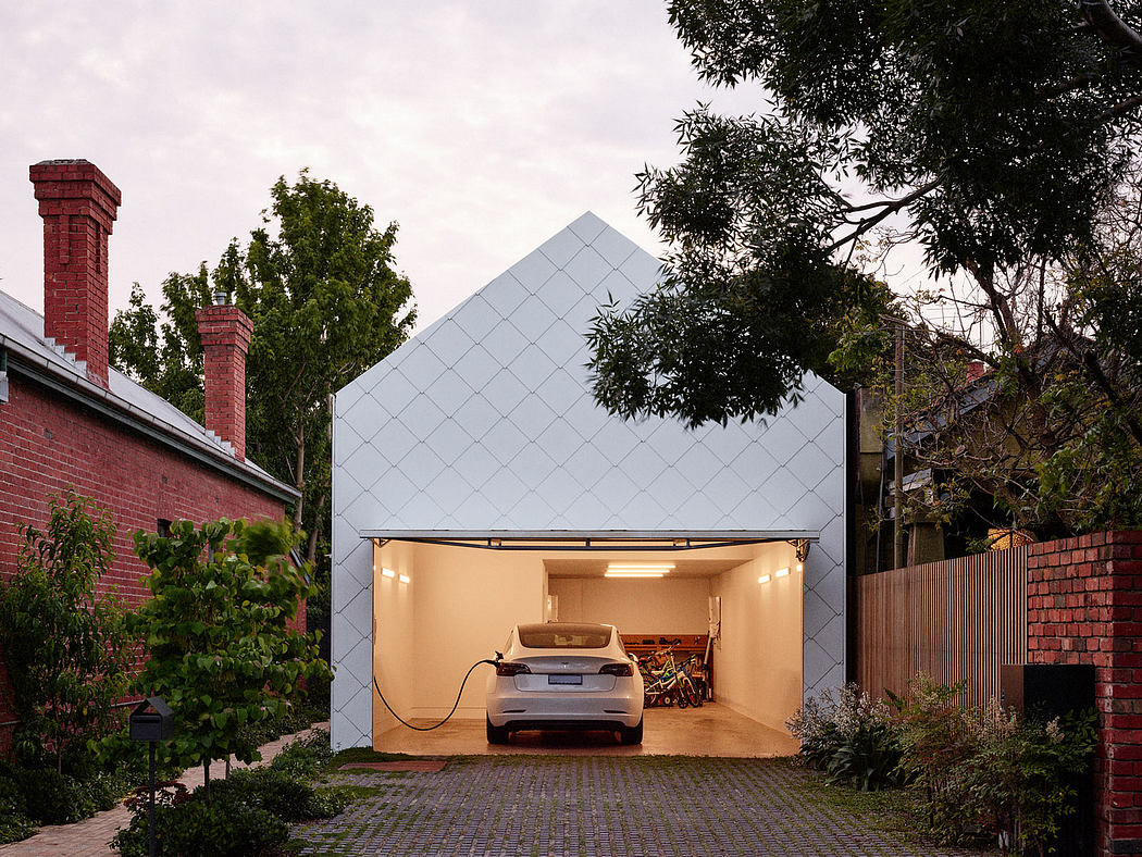 Modern carport with geometric design, electric car, and mural, between traditional brick