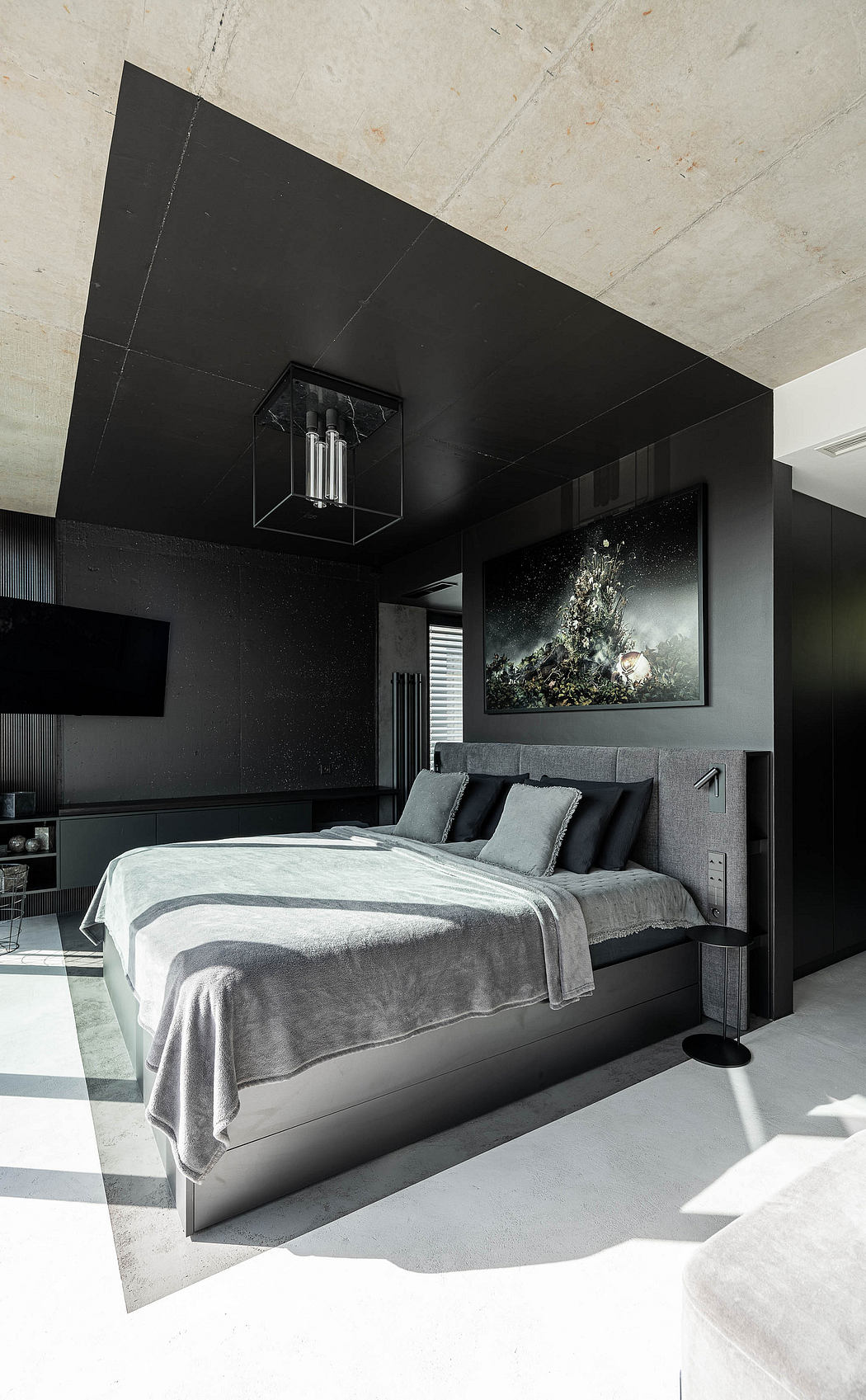 Contemporary bedroom with monochrome decor and geometric accents.