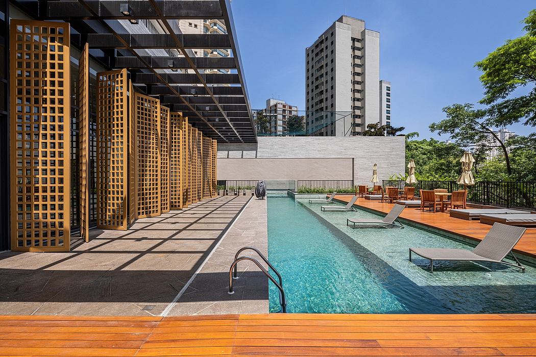 Urban poolside with wooden deck and geometric screens.