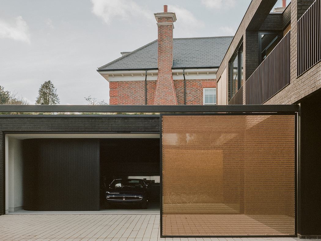 Contemporary open garage with a brick house facade in the background.