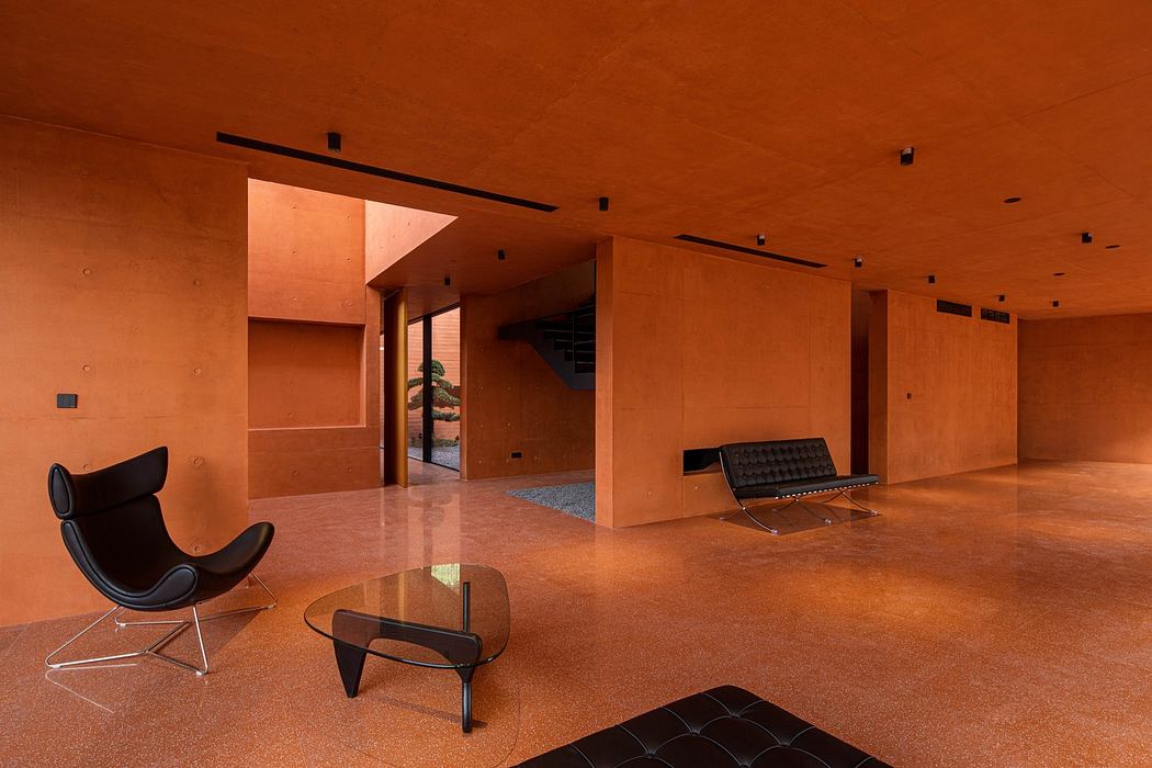 Contemporary interior with terracotta walls and minimalist furniture.