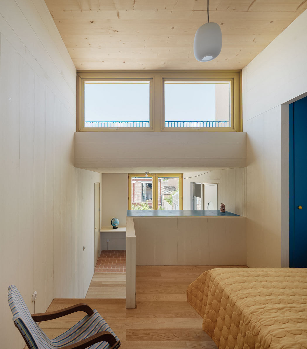 Modern room with high ceiling, mezzanine, wooden floors, and minimalistic