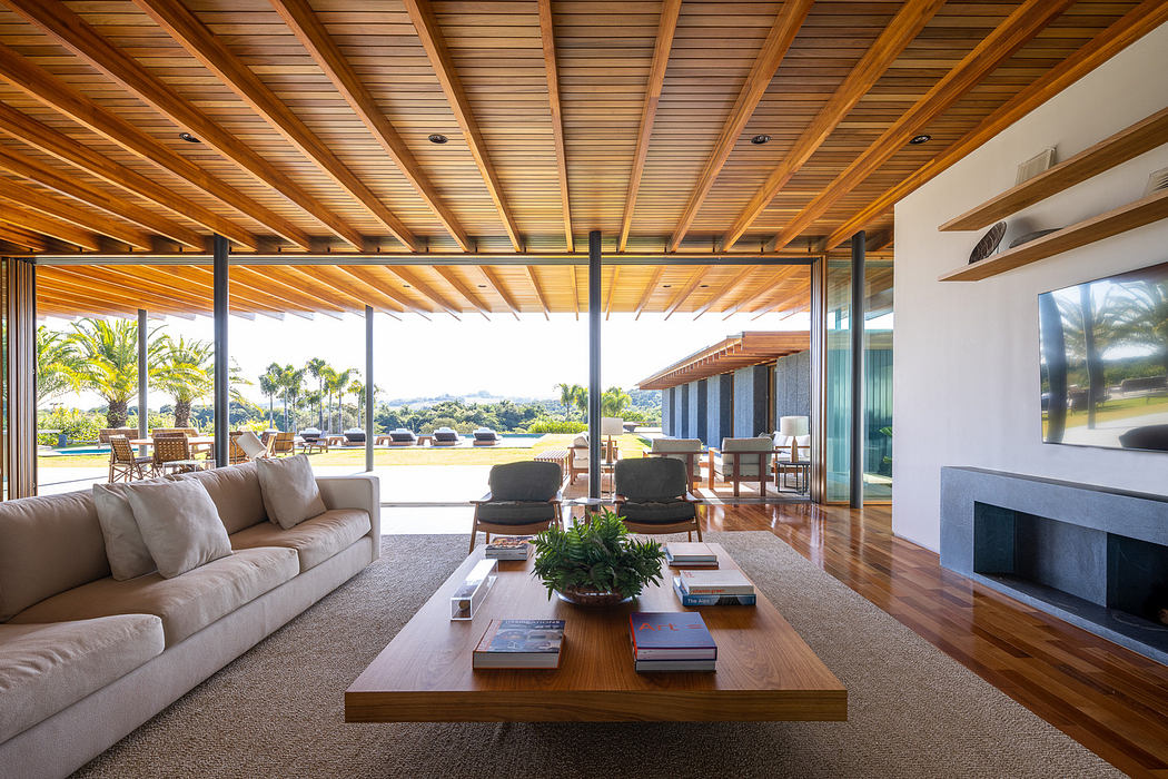 Spacious living room with wooden ceiling and floor-to-ceiling windows.