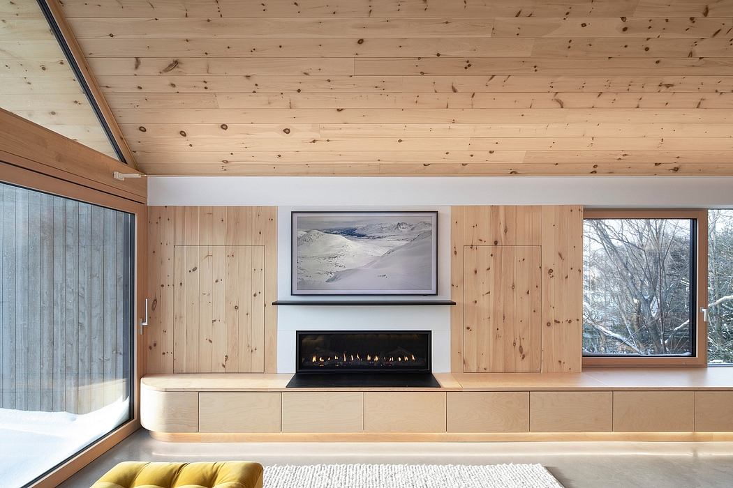 Minimalist room with wood paneling, bench fireplace, and large window.