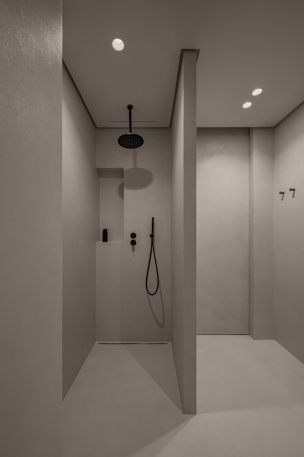 Minimalist shower with geometric design and monochrome palette