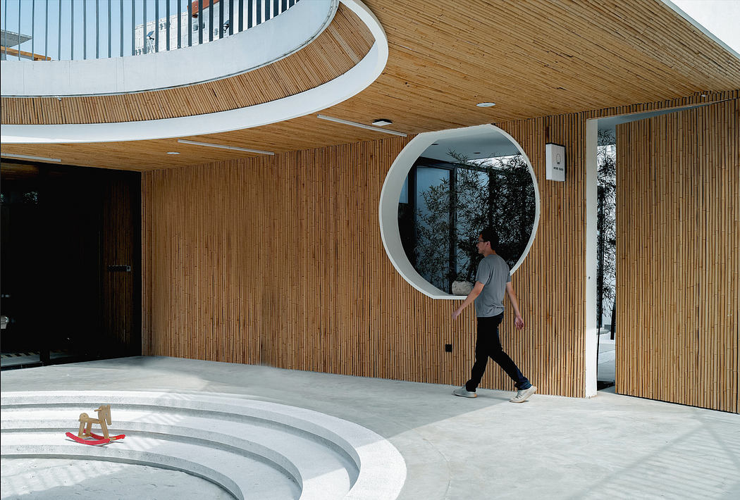 Modern interior with curved wood walls and unique circular doorway.