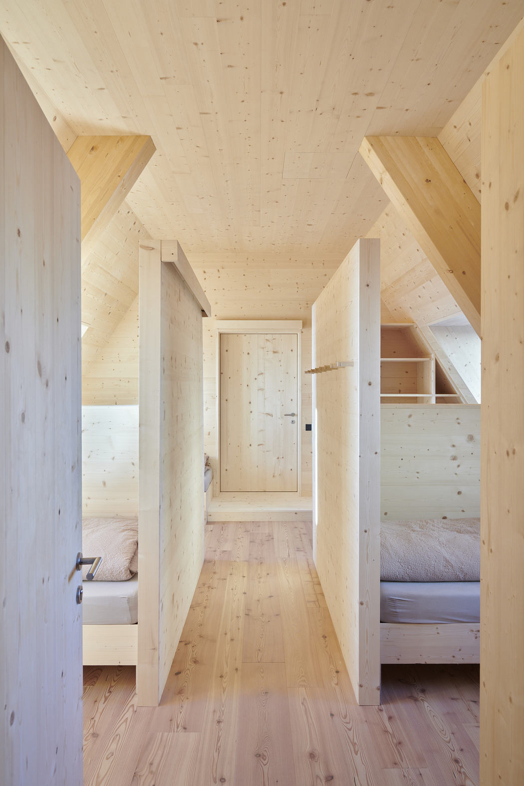Minimalist wooden interior hallway with bedrooms.
