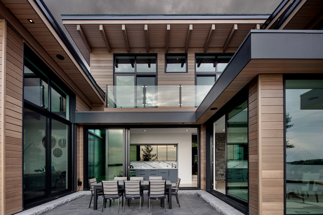 Contemporary house with glass balcony and outdoor dining area