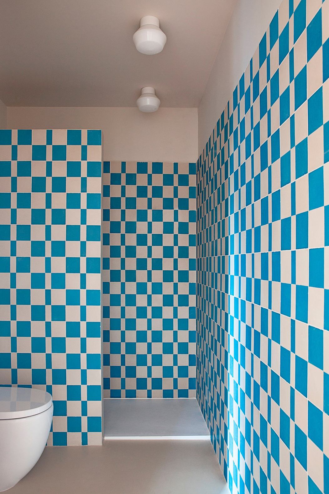 Modern bathroom with blue and white checkered tile walls.