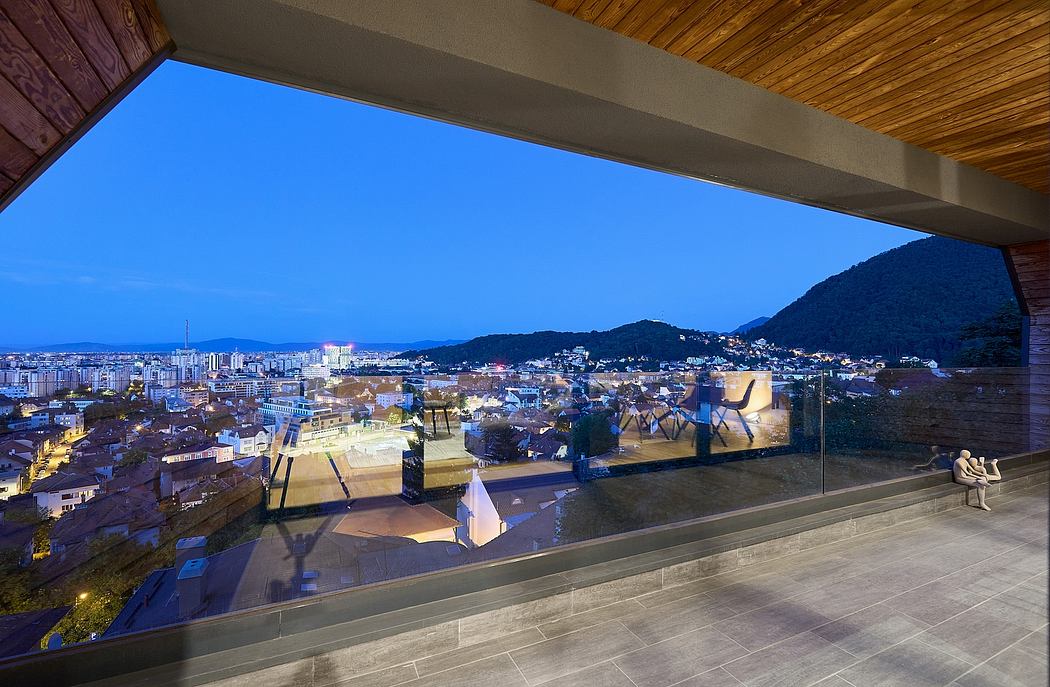 Elevated indoor space with panoramic city view through glass walls, wooden ceiling,