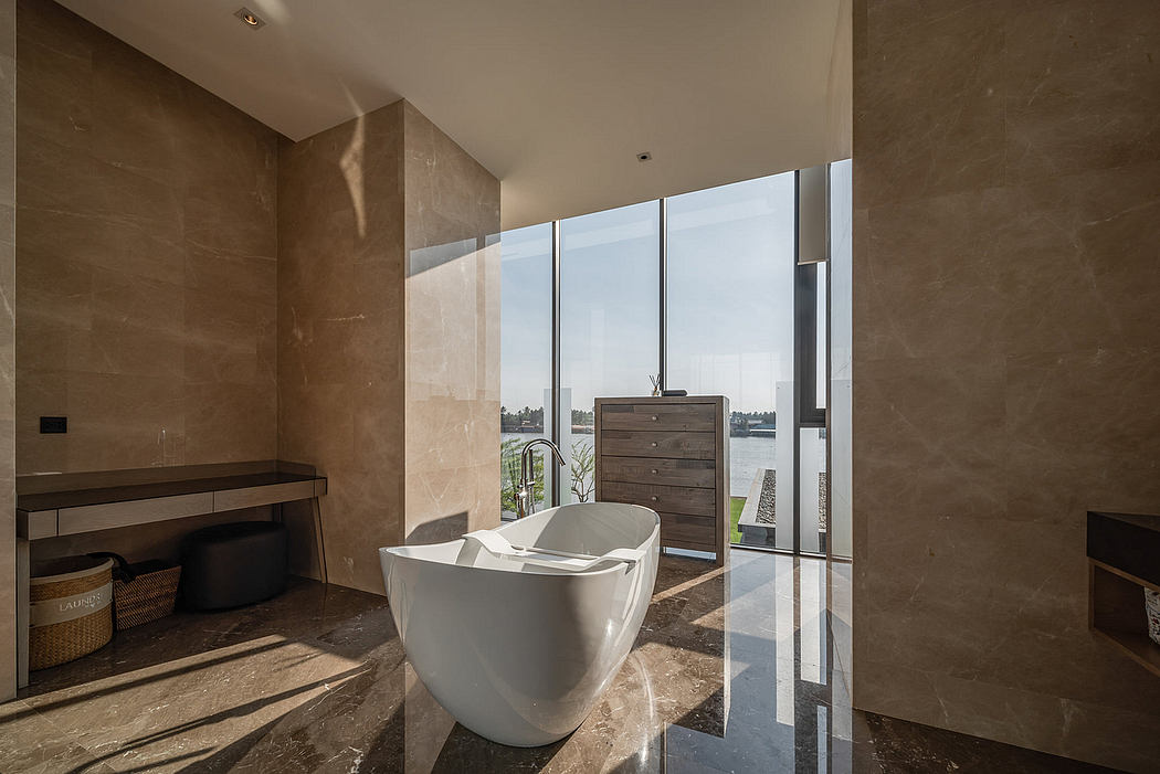 Modern bathroom with freestanding tub and floor-to-ceiling windows.