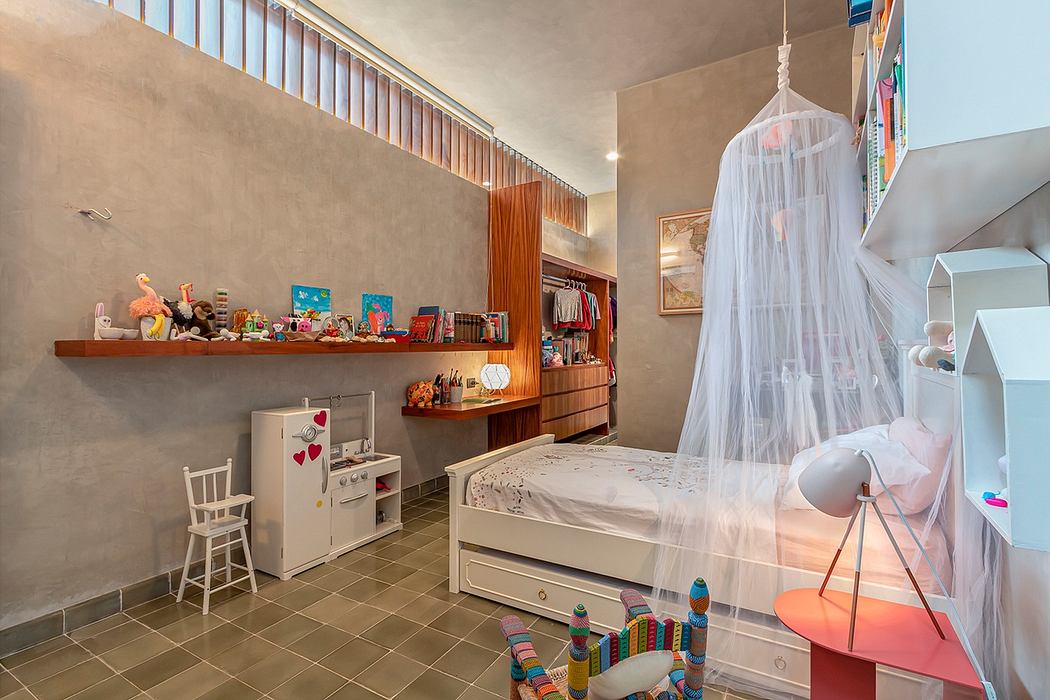 Child's bedroom with a white bed, toys, and colorful decor.