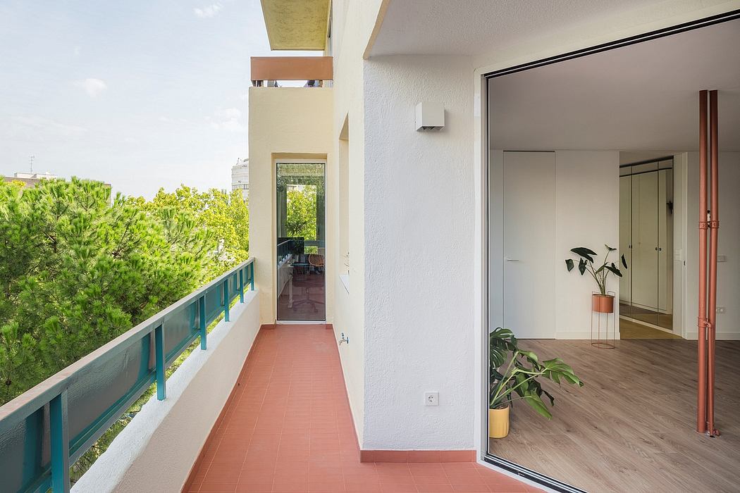 Bright, airy apartment balcony with greenery view and indoor peek.