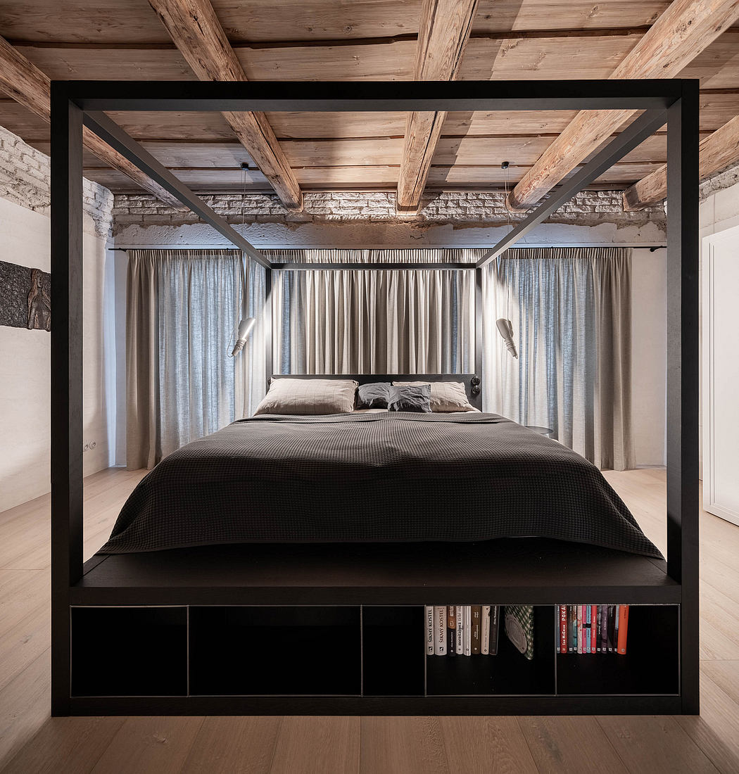 Modern bedroom with exposed beams, black bed frame, and surrounding sheer curtains.