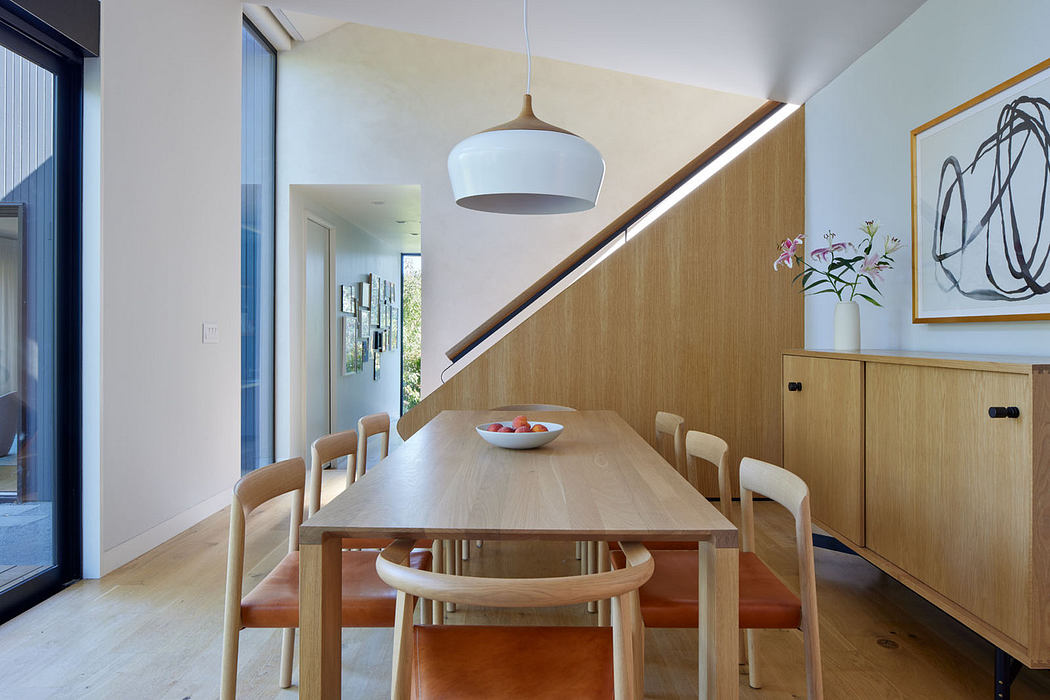 Sleek dining room with wood furnishings and pendant lighting