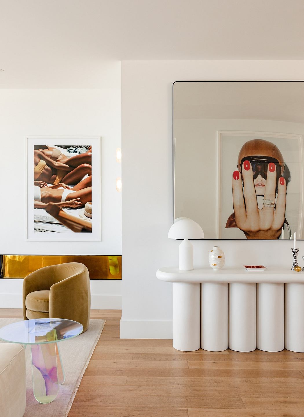 Modern room with art posters, unique white console and velvet chair.