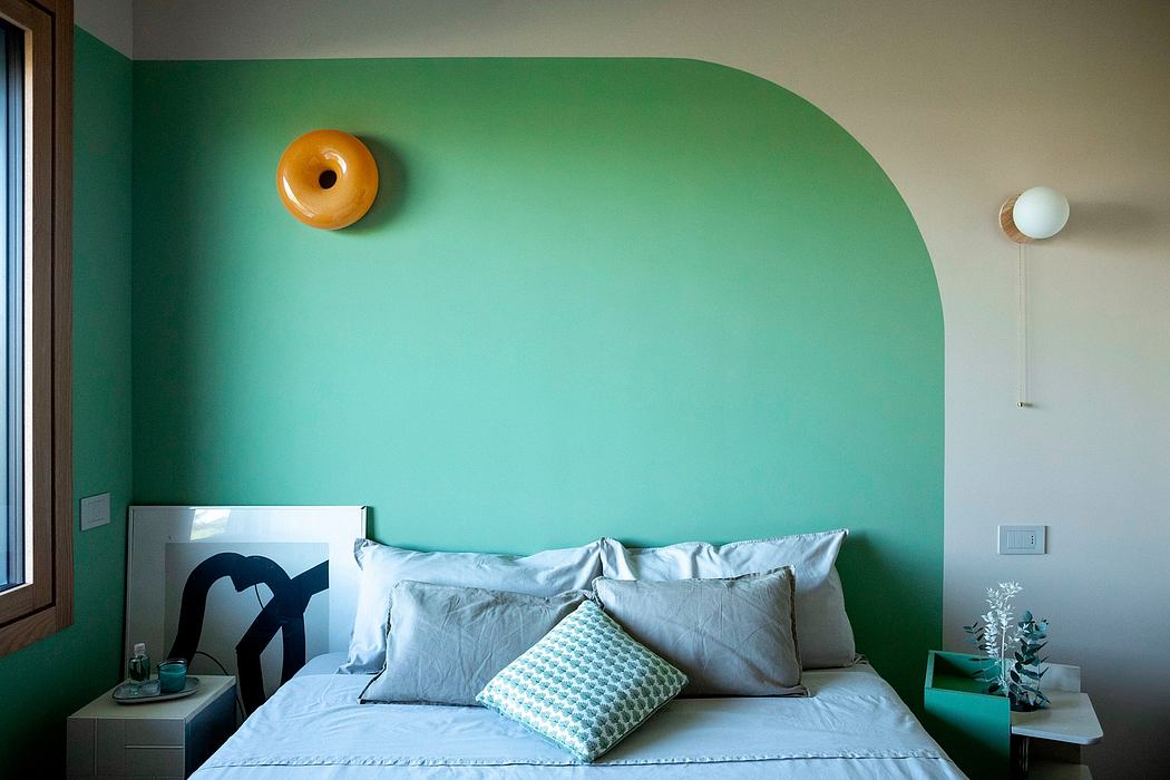 Modern bedroom with a green accent wall and minimalist decor.