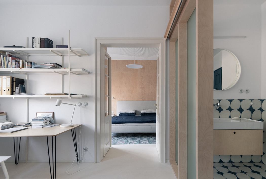 Modern home interior with study area and view into bedroom.