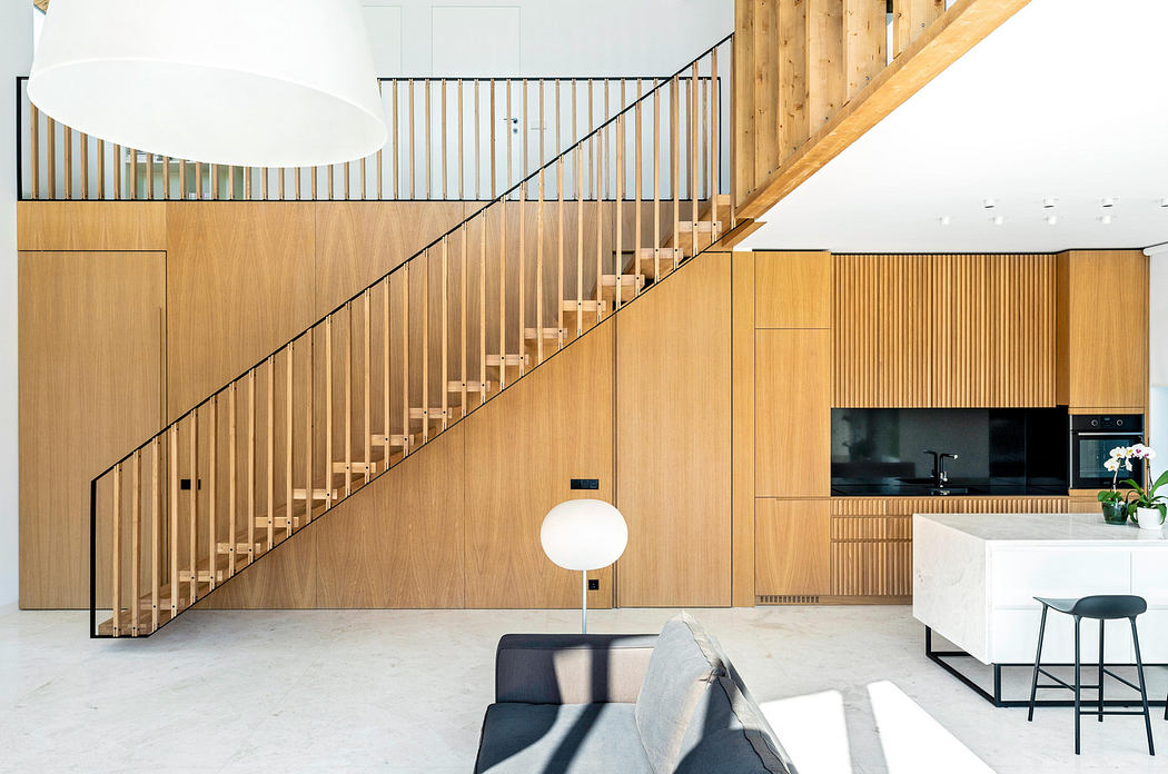 Modern interior with wooden staircase and sleek kitchen design.