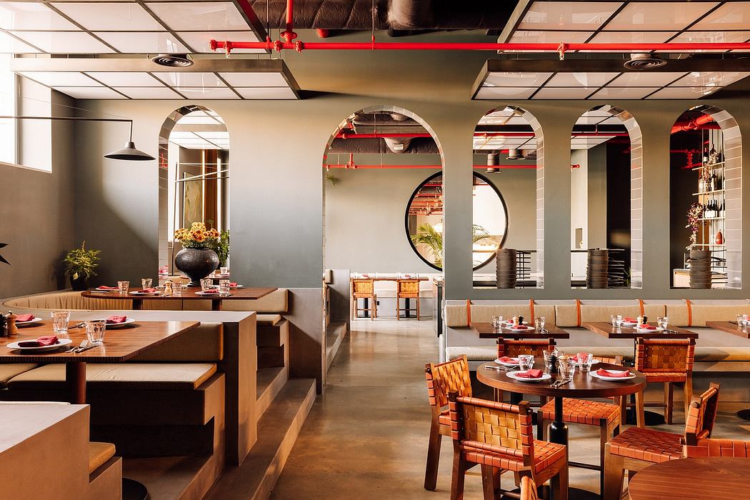 Modern dining room with arched openings and industrial ceiling.