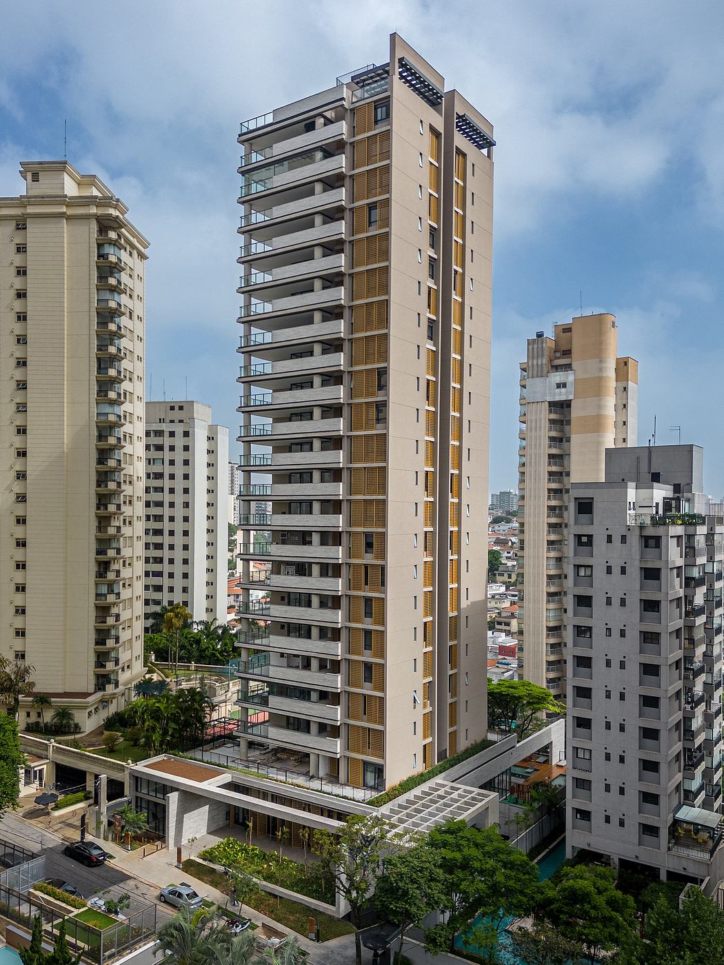 Contemporary high-rise residential building with balconies amidst cityscape.
