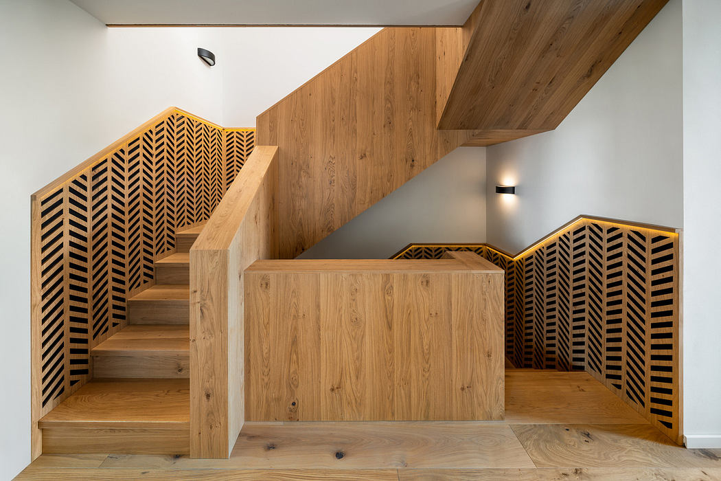 Modern wooden staircase with patterned side panels.