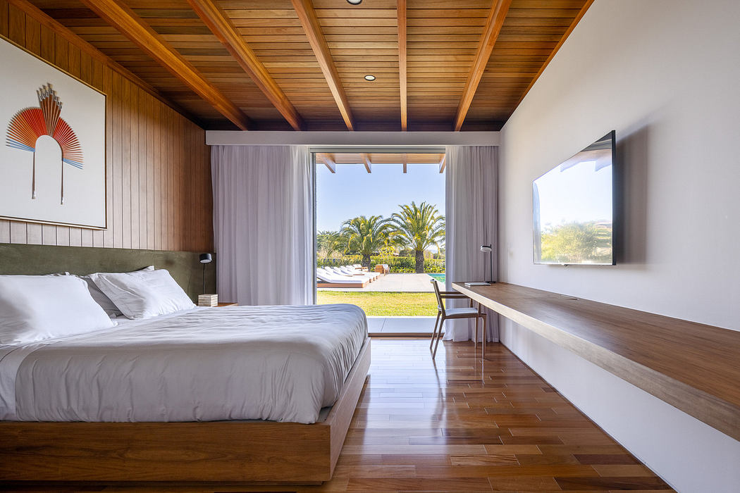 Contemporary bedroom with wood accents and tropical view.