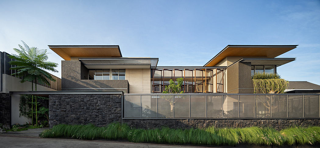 Modern house with geometric design, large windows, and cantilevered roofs.