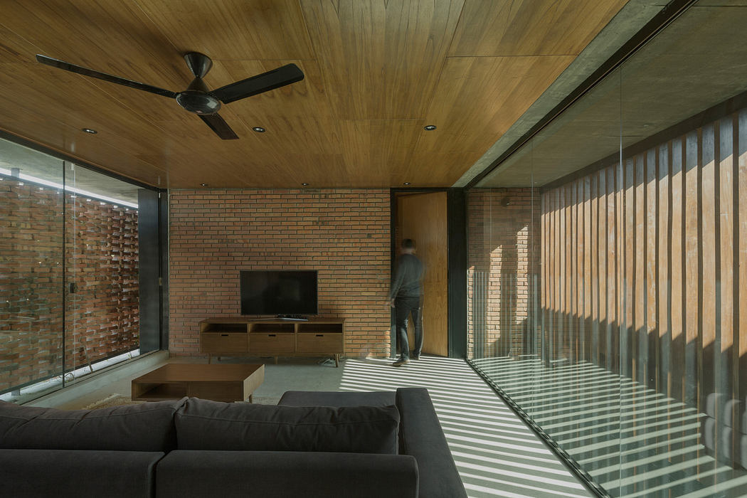Contemporary living space with wooden ceilings and brick walls.