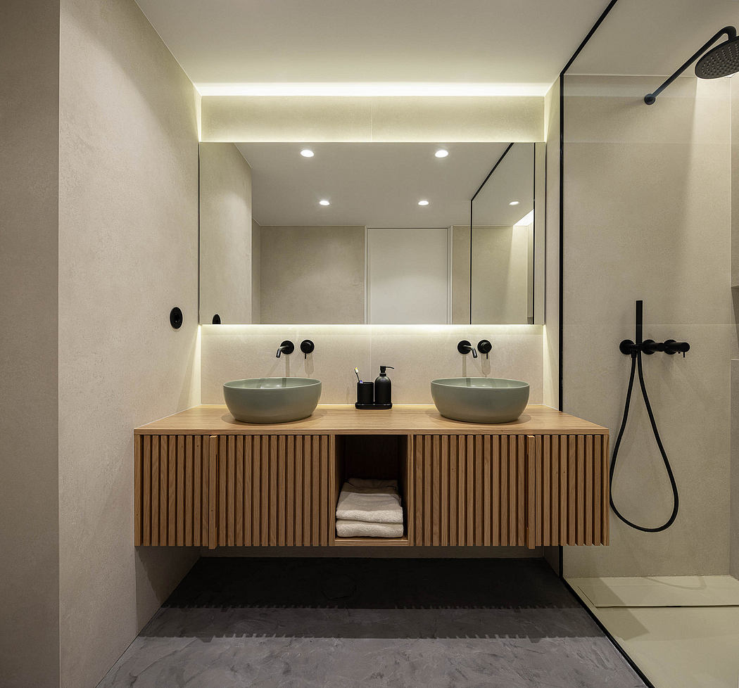 Contemporary bathroom with dual vessel sinks and wooden vanity.