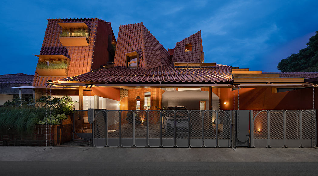 Contemporary house with distinctive terracotta roofs at dusk.