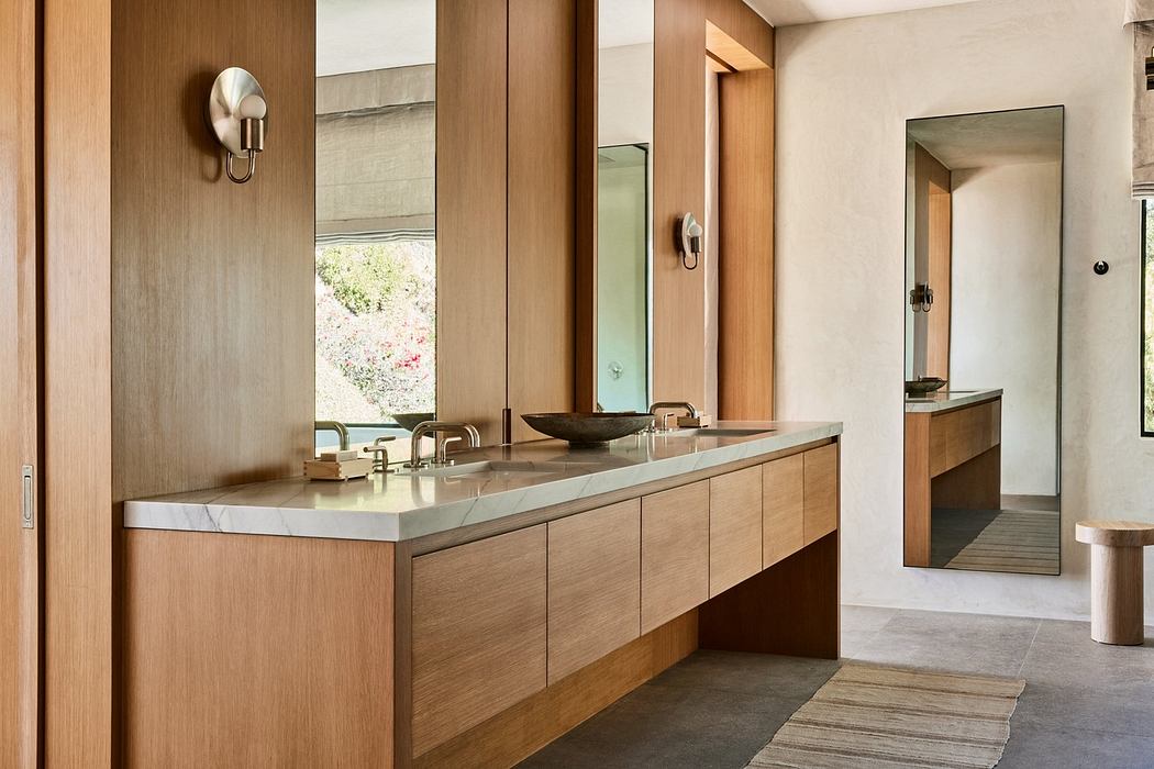 Modern bathroom with wooden vanity and sleek fixtures.