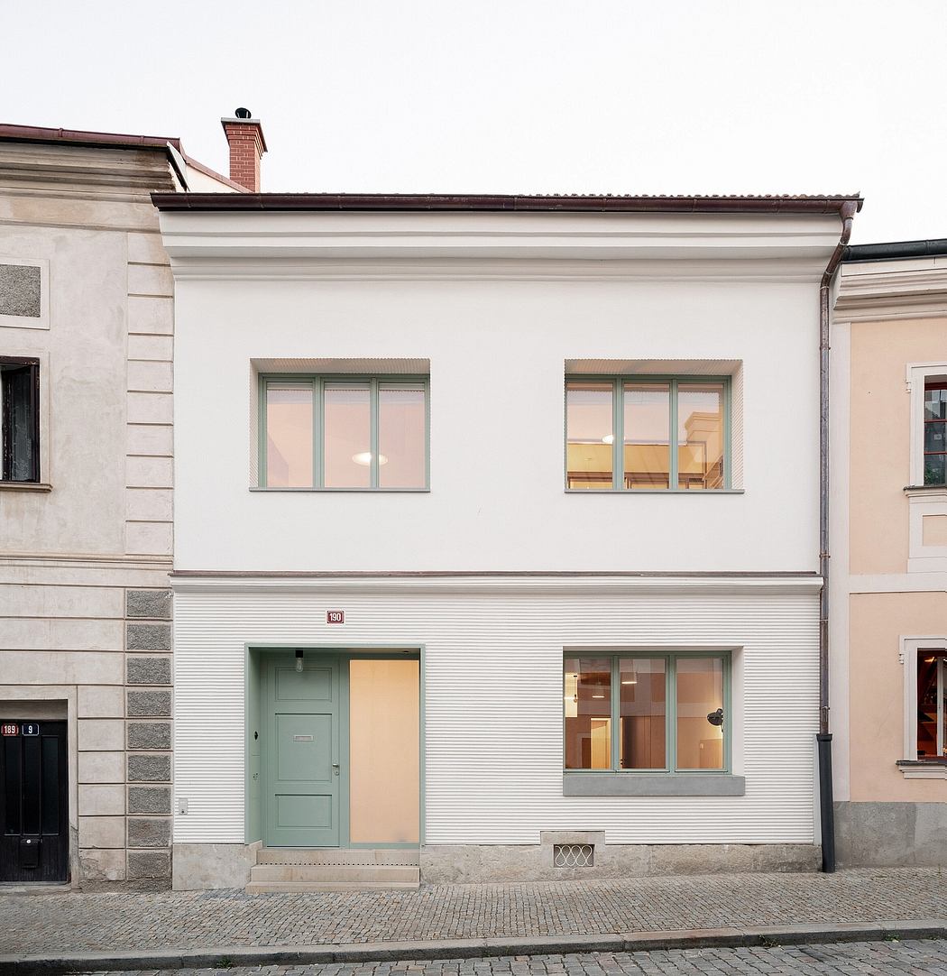 Sleek two-story urban house with pastel door
