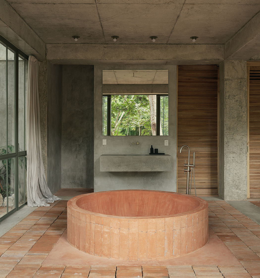 Minimalist bathroom with concrete walls and terracotta tub.