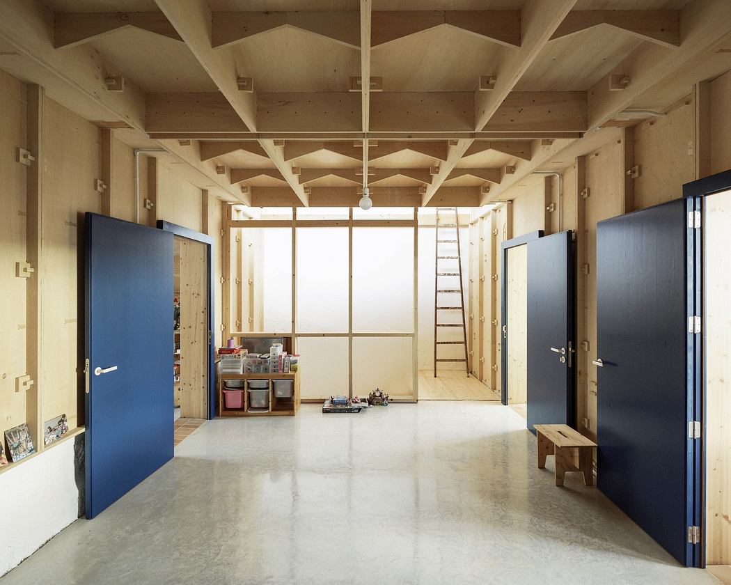Minimalist interior with exposed wooden beams, blue doors, and polished concrete floor.