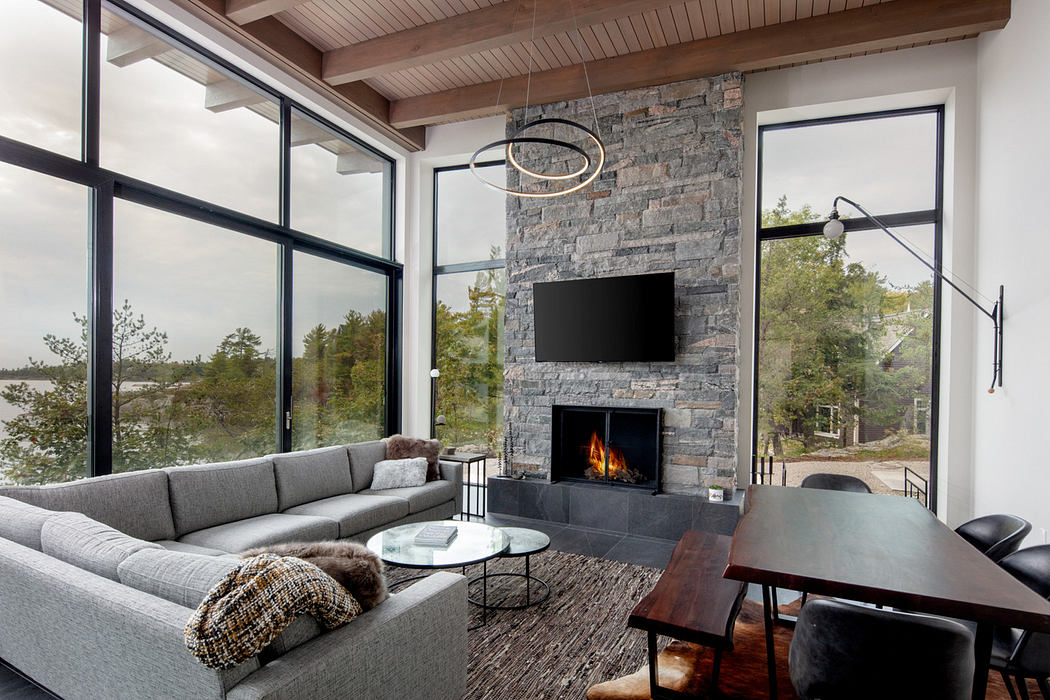 Contemporary living room with fireplace and floor-to-ceiling windows.