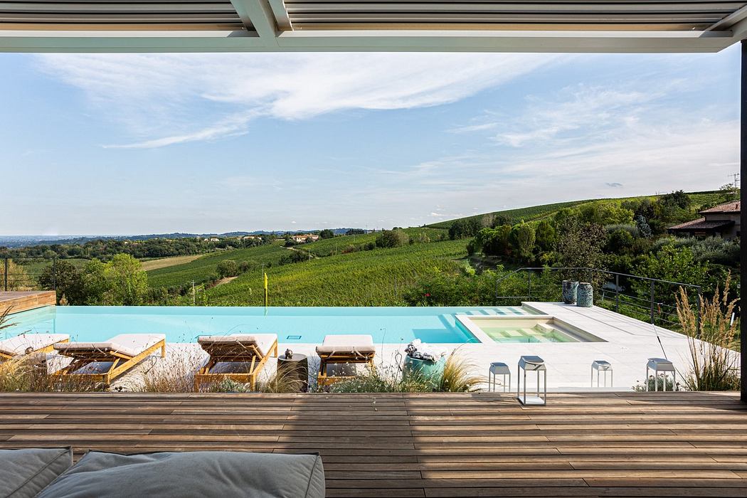 Luxurious poolside terrace overlooking a scenic landscape.