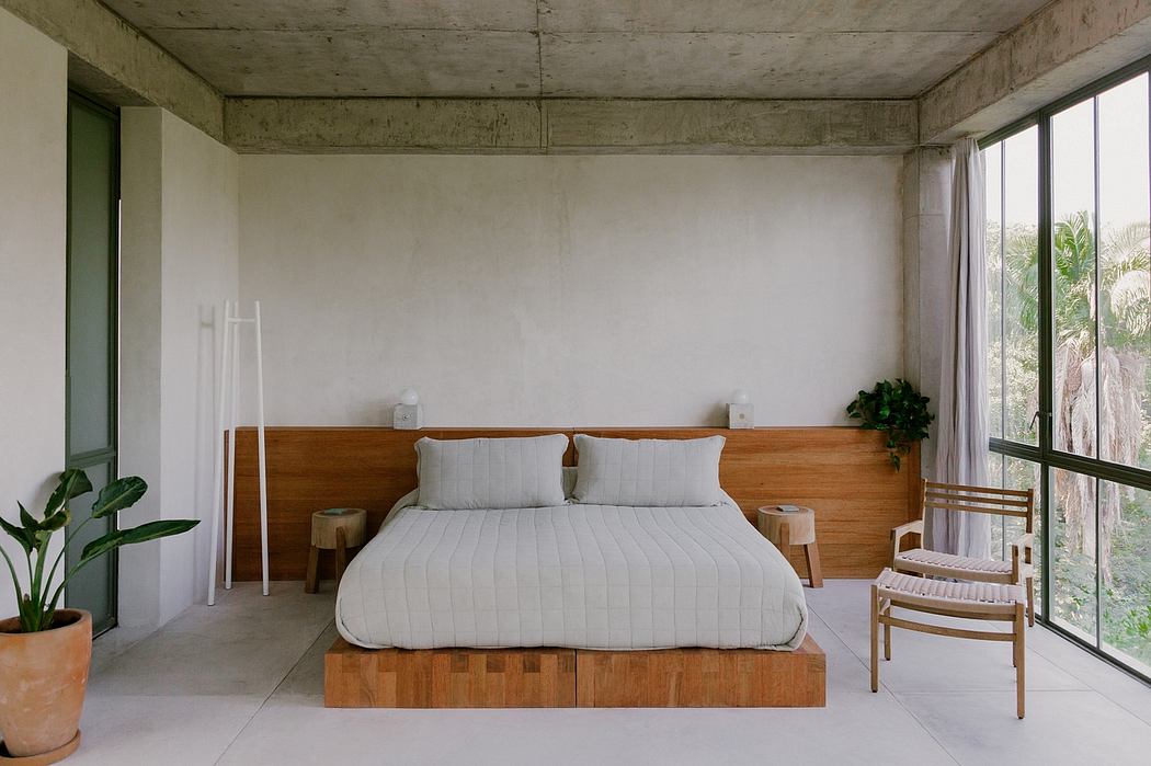 Modern bedroom with concrete walls, wooden bed, and large window.