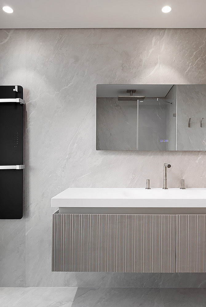 Modern bathroom with marble walls, floating vanity, and minimalist design.