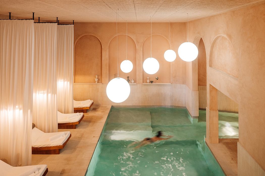 Contemporary spa interior with arched walls, hanging orbs of light, and a