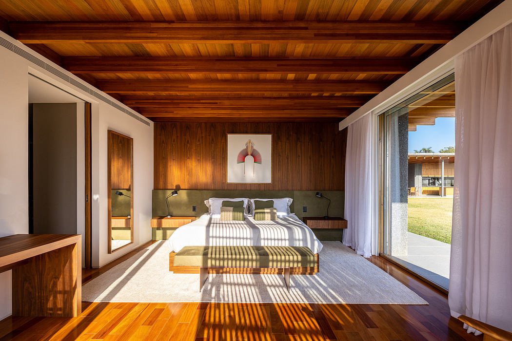 Modern bedroom with wooden ceiling and floors, large windows, and a green bedspread