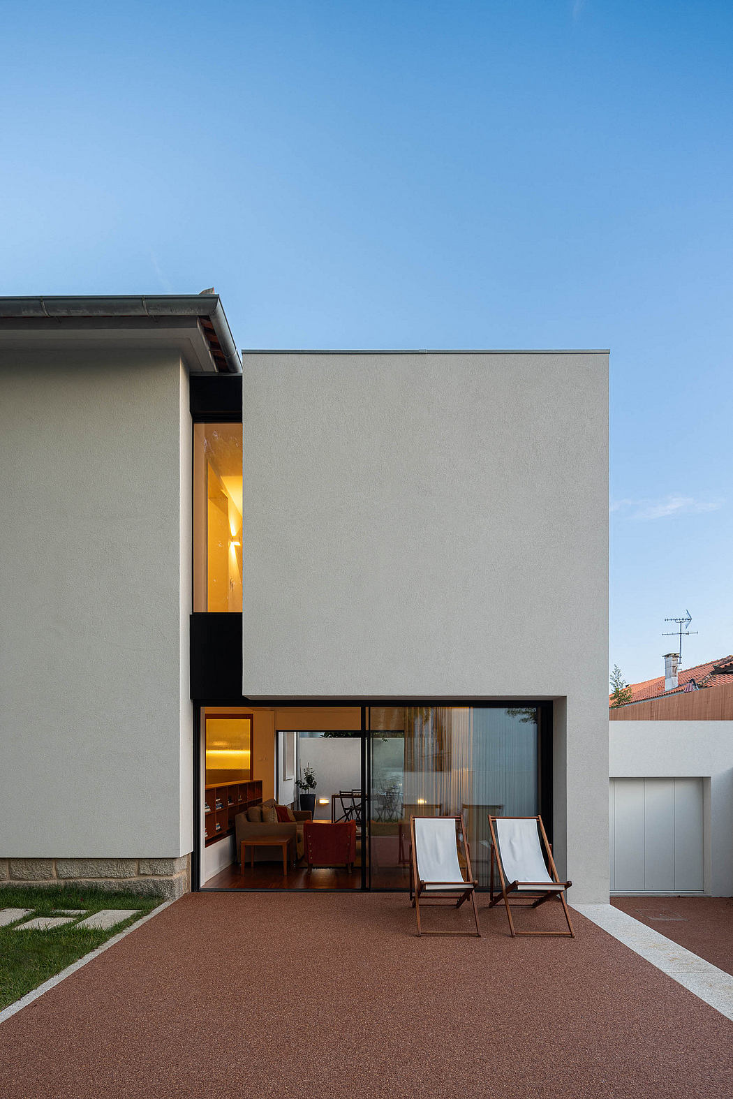 Contemporary home exterior with large glass doors and minimalist design.