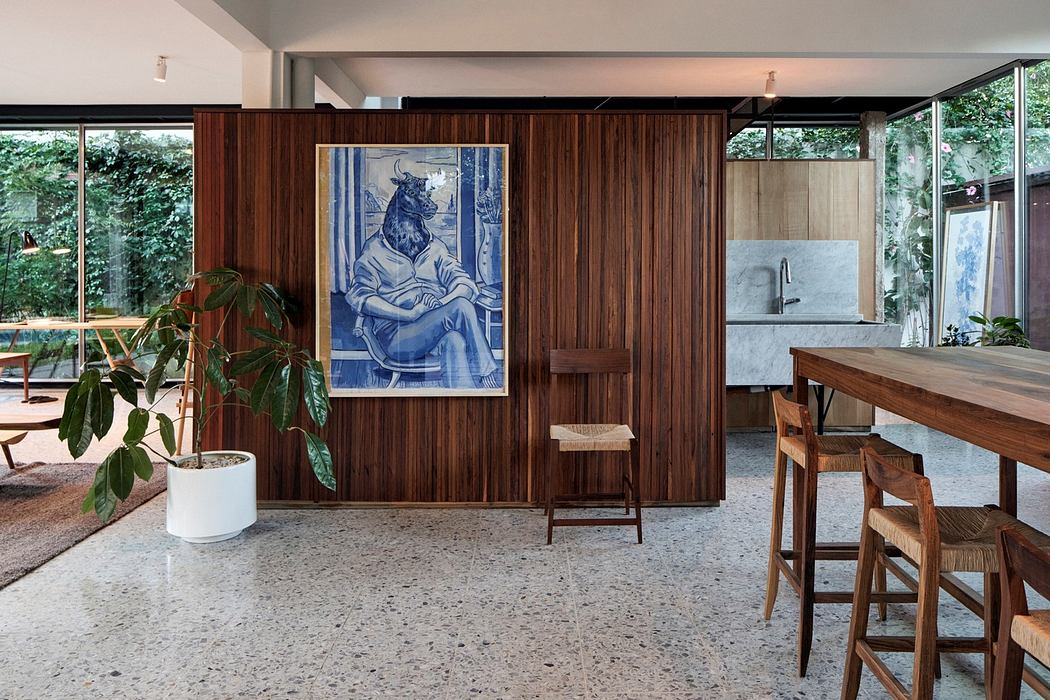Contemporary interior with wooden paneling, terrazzo floor, and large artwork.