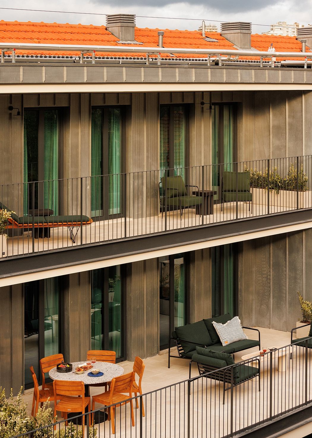 Modern apartment balconies with outdoor furniture and plants.